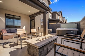 An outdoor patio with a fire feature, seating, and a grill. - Brand New Skyline Resort 1737, Private Hot tub, Resort Access, & Near Sand Hollow Lake (Washington)