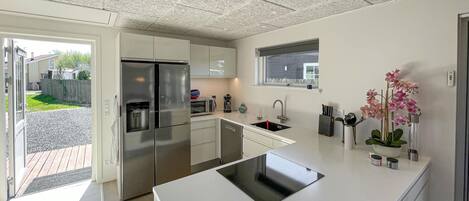 Fridge, dishwasher, coffee/tea maker, cookware/dishes/utensils