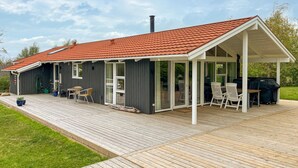 A house with a covered patio, a grill, and a garden. - Awesome home in Farsø with sauna (Farsø)