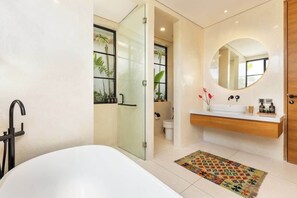A modern bathroom with a bathtub, a glass shower enclosure, a wooden vanity, and a large mirror. - PianoPiano Villas in Uluwatu. Breakfast included! (Pecatu)