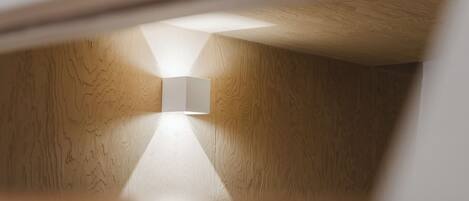 Una habitación con paredes de madera y una lámpara moderna.