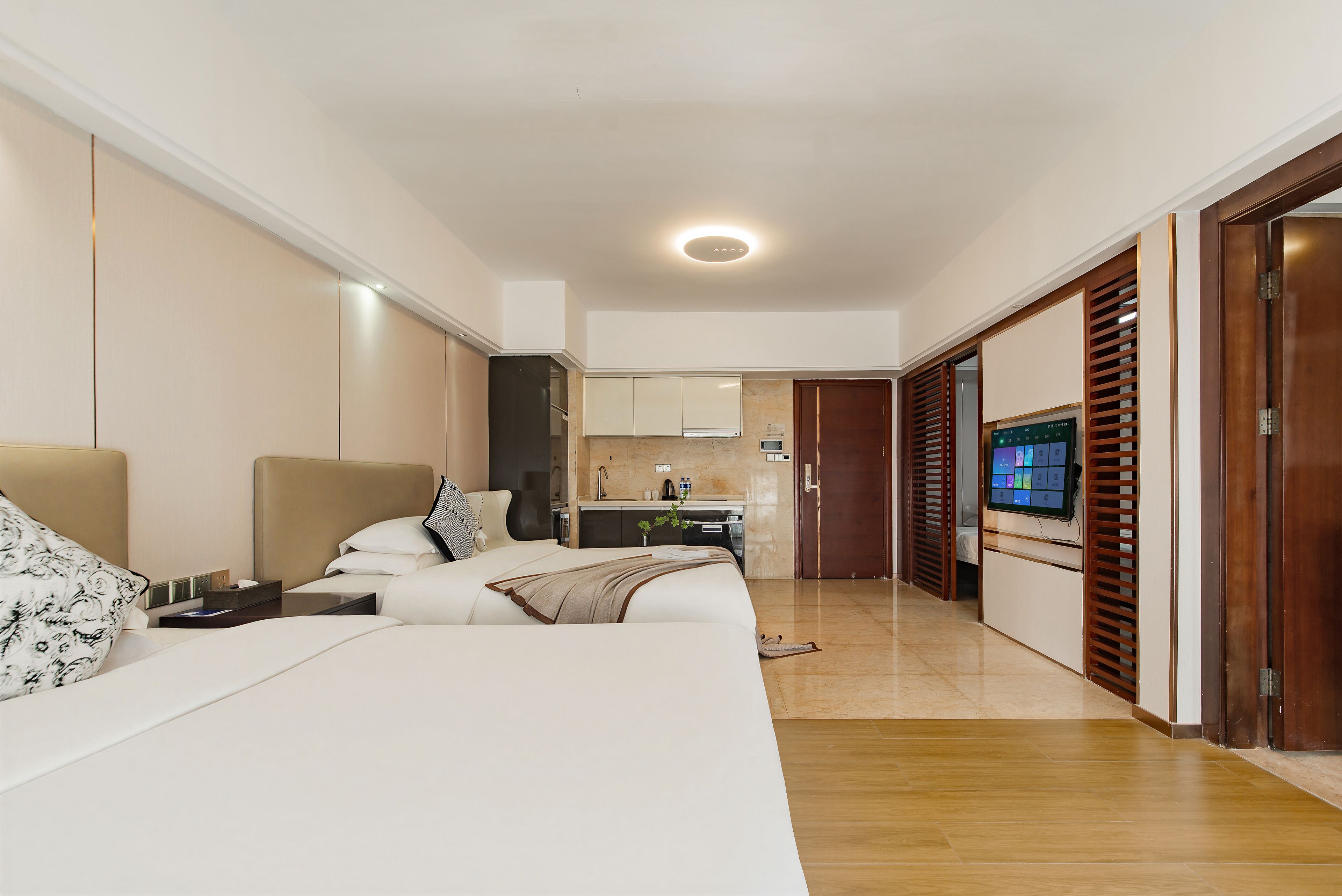 Ein modernes Hotelzimmer mit Bett, Schreibtisch, Fernseher und Badezimmer.