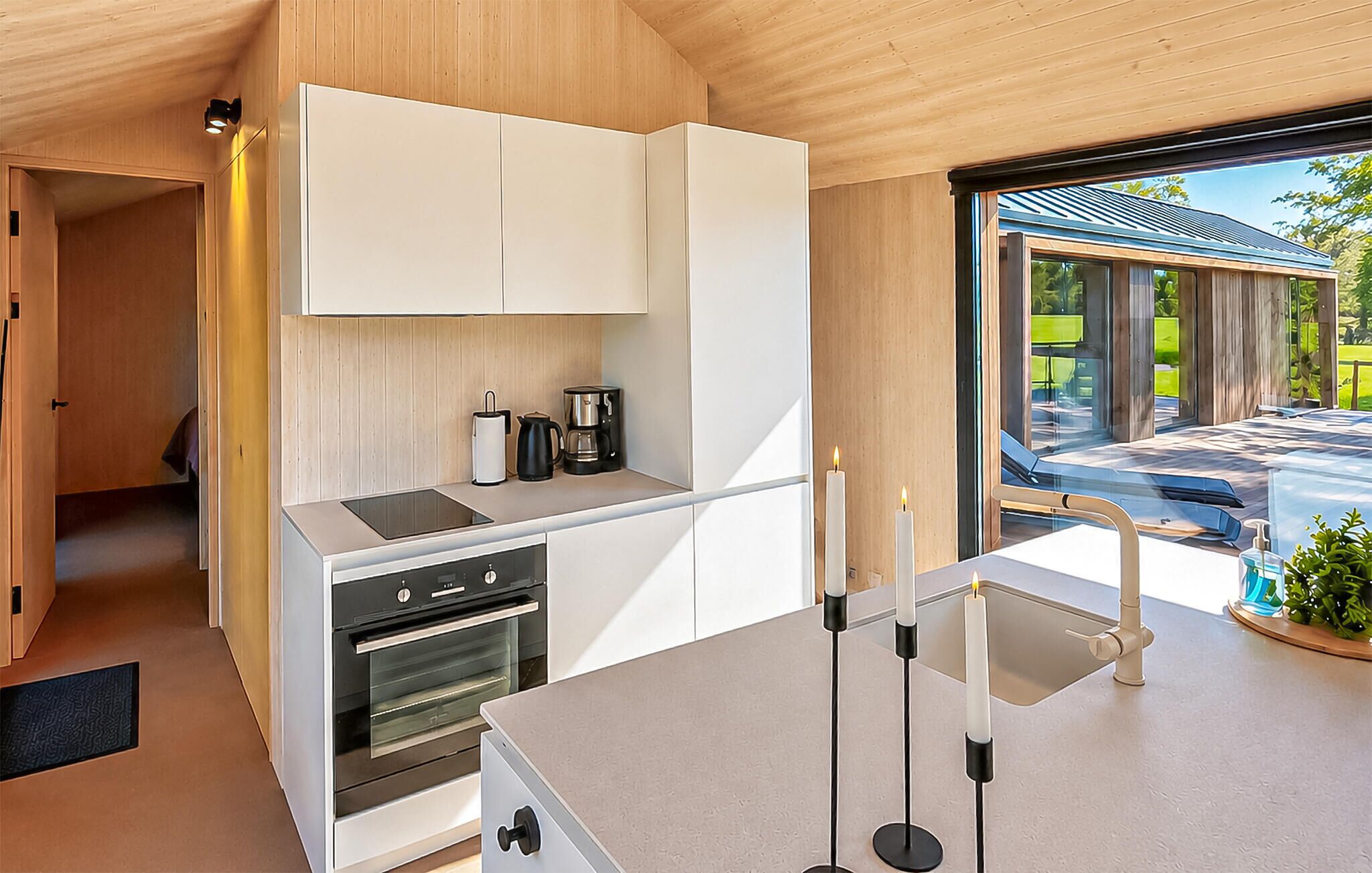 A modern kitchen with built-in appliances, a dining area with a view, and a minimalist design.