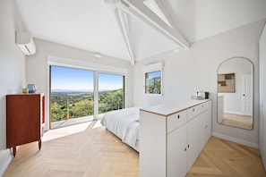 A bedroom with a bed, a dresser, a large mirror, and a view through a sliding glass door. - Air-conditioned dream villa with lagoon-style pool and sea view for 6 guests in La Londe-les-Maures (LA LONDE LES MAURES)