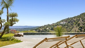 A poolside area with a view of a hillside and distant landscape. - Air-conditioned dream villa with lagoon-style pool and sea view for 6 guests in La Londe-les-Maures (LA LONDE LES MAURES)