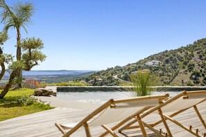 A poolside area with a view of a hillside and distant landscape. - Air-conditioned dream villa with lagoon-style pool and sea view for 6 guests in La Londe-les-Maures (LA LONDE LES MAURES)