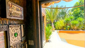 A room with a jungle-themed decor, including a 'JUMANJI' sign and a 'JUMANJI' game console. - PATTAYA LAND - You Only Live Once (Pattaya)