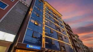 A multi-story hotel with a modern facade, large windows, and a prominent 'FabHotels' sign. - i residency copital o (Bangalore)