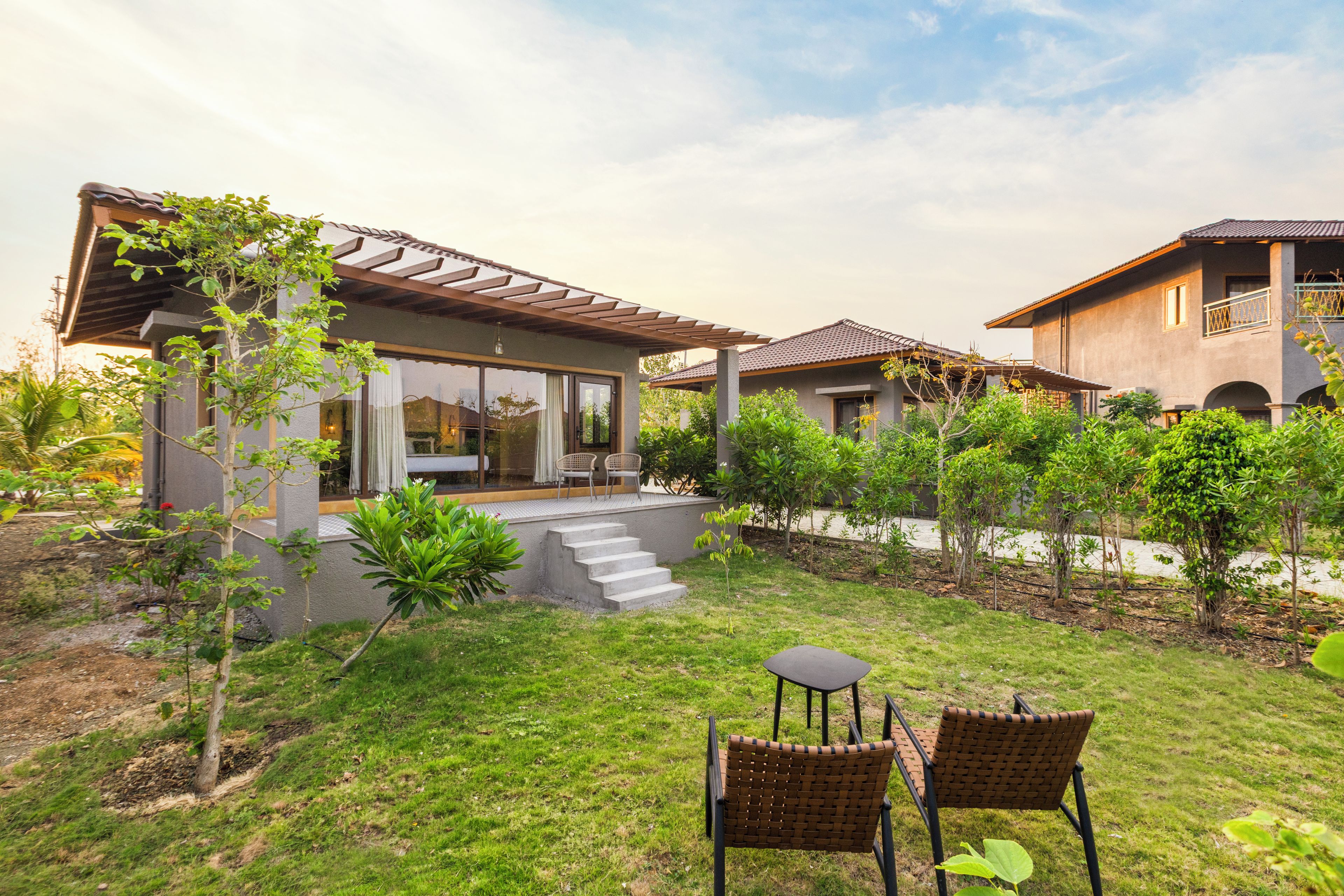 A residential property with a patio, outdoor seating, and a garden.