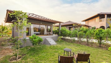 A residential property with a patio, outdoor seating, and a garden.