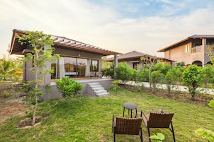 Una propiedad residencial con patio, mobiliario exterior y jardín.