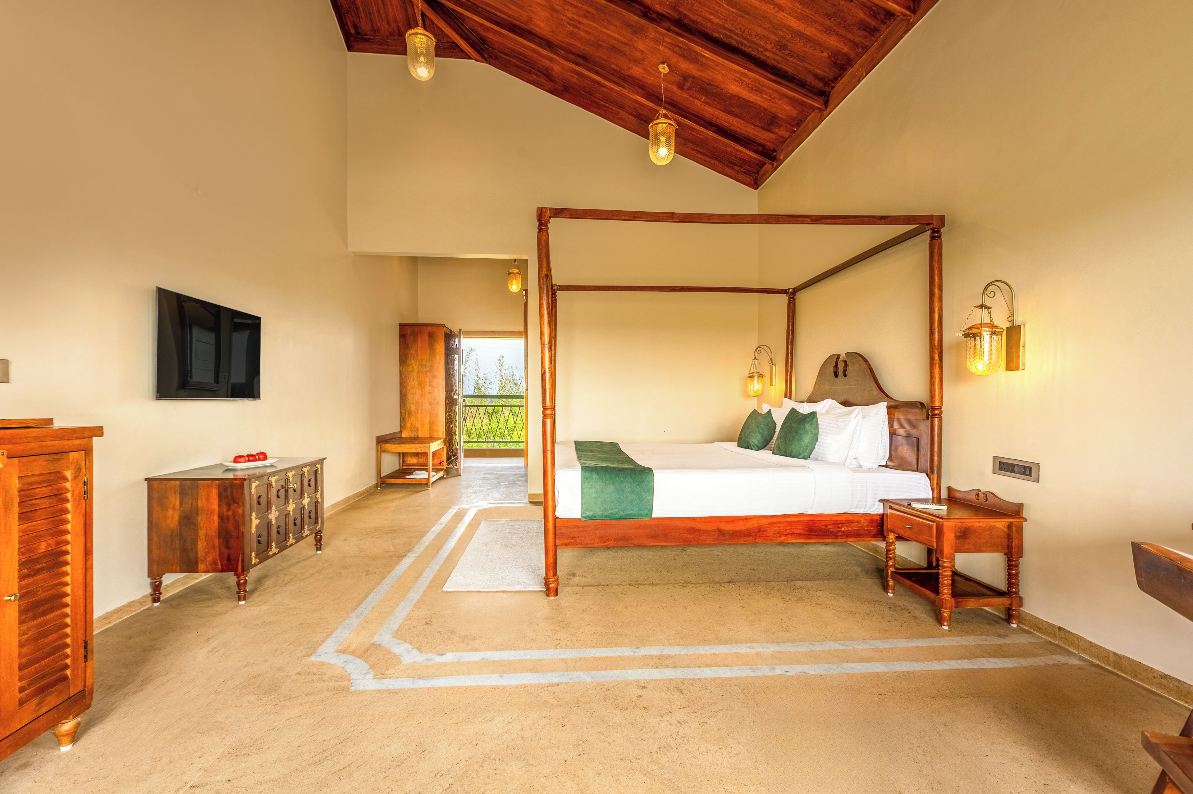A four-poster bed with a wooden headboard, a bedside table, and a nightstand.