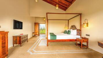 A four-poster bed with a wooden headboard, a bedside table, and a nightstand.