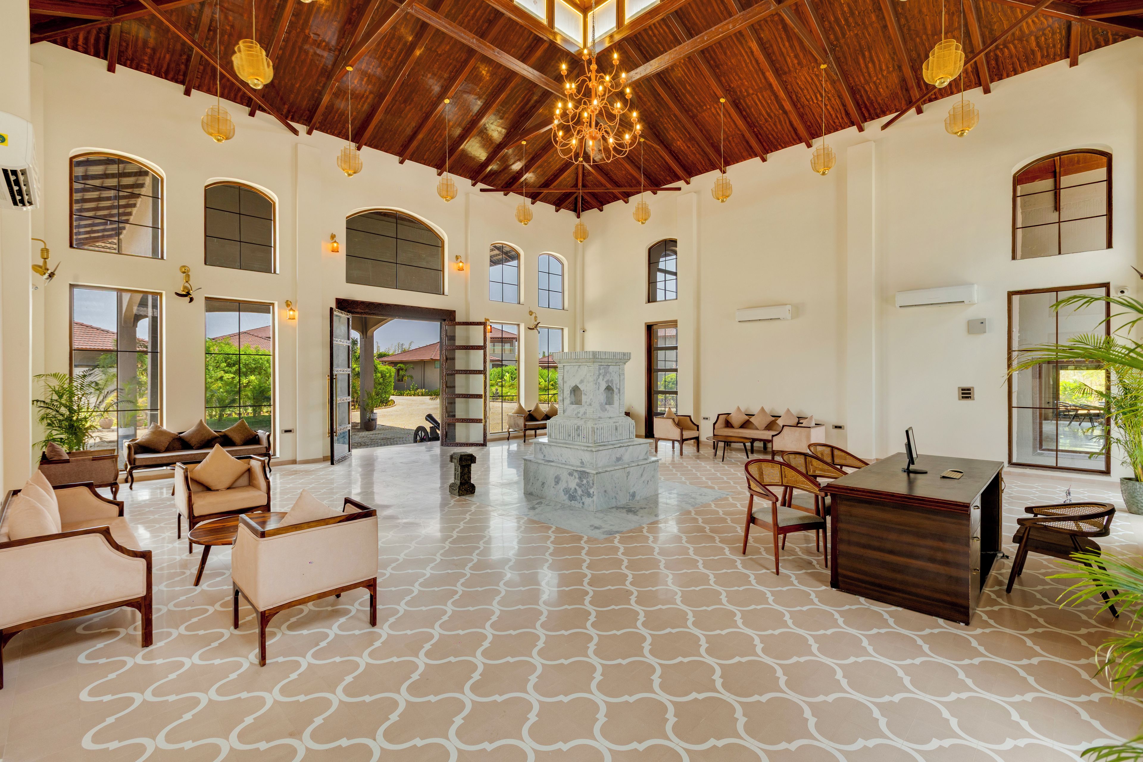 A spacious lobby with a high ceiling, multiple seating areas, and a central decorative fountain.