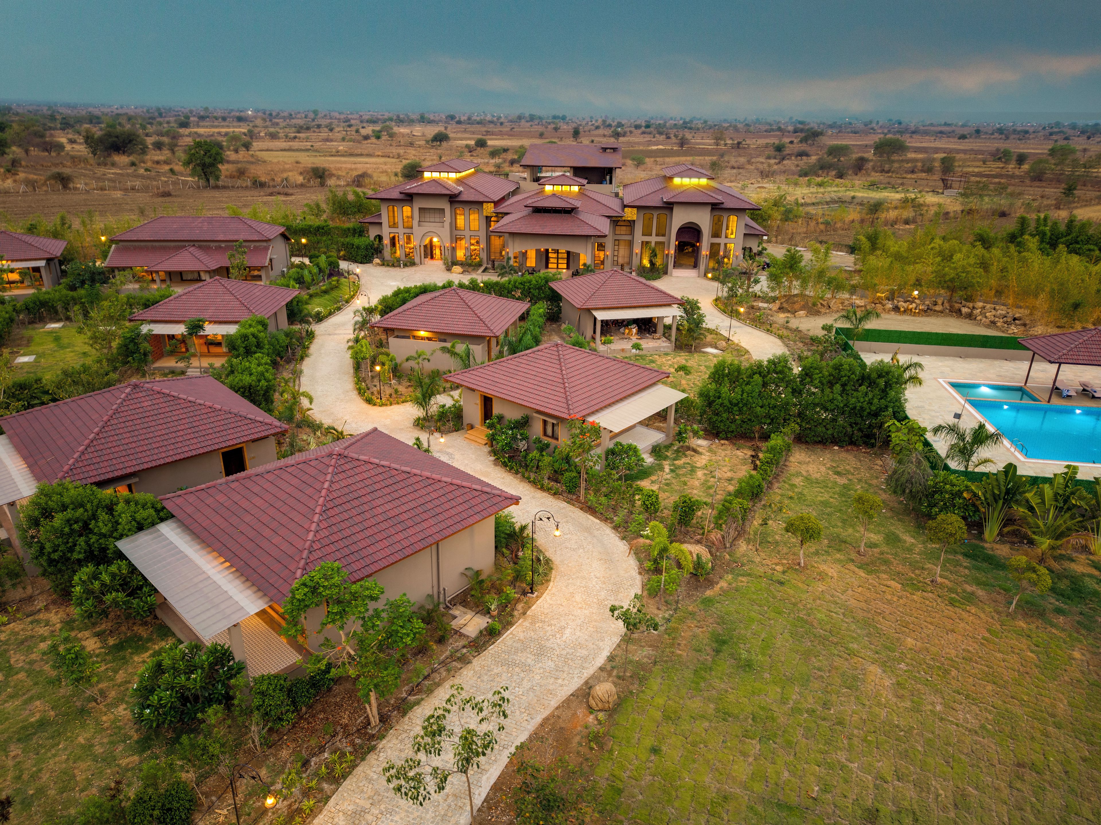 A residential area with multiple houses, a swimming pool, and a well-maintained garden.