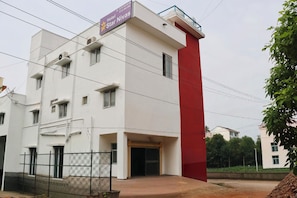 Um edifício de vários andares com uma placa indicando que é um hotel chamado 'Star Nivas'.