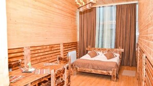 A wooden room with a bed, a table, and a chair. - ZANGEZUR HOTEL GORIS (Goris)