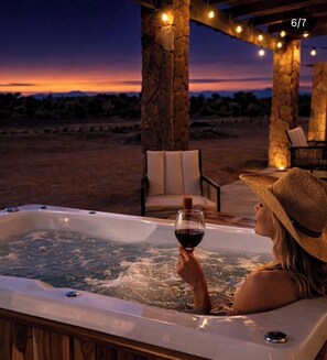 A hot tub with a sunset view, stone pillars, and string lights. - Baja Toscana Private Wine CountryRetreat (Valle de Guadalupe)