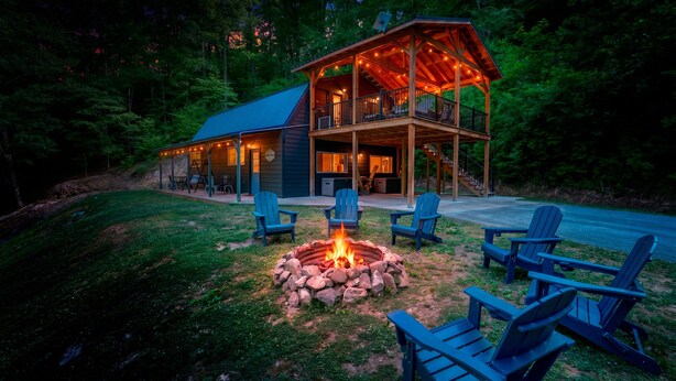 A cabin with a fire pit, outdoor seating, and a covered porch. - Bear Ridge BaseCamp at Buffalo Creek | Pet-Friendly Lake Lure Cabin with Views, Firepit & Game Room (Lake Lure)