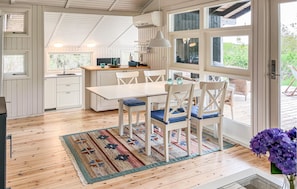 A kitchen with white cabinets, a wooden countertop, and a hanging pendant light. - 3 bedroom amazing home in Brovst (Brovst)