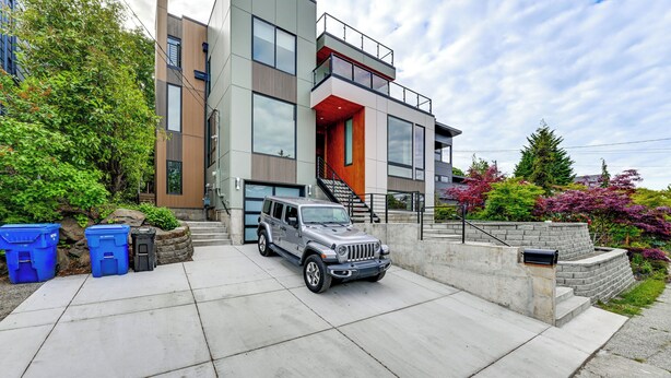 A modern two-story house with a garage, a driveway, and a mailbox. - Walk to Seward Park! Pet-Friendly Apt w/ Turf Yard (Seattle)