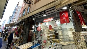 A narrow street with shops on either side, including a jewelry store with glass display cases. - KAAN AİLE PANSİYON (Amasra)