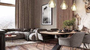 Un soggiorno moderno con divano, tavolo da pranzo, sedie, lampadari a sospensione, un quadro incorniciato e una testa di cervo decorativa.