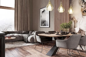 A modern living room with a sofa, dining table, chairs, pendant lights, a framed picture, and a decorative deer head. - Modern apartment in a quiet location (Ladis)