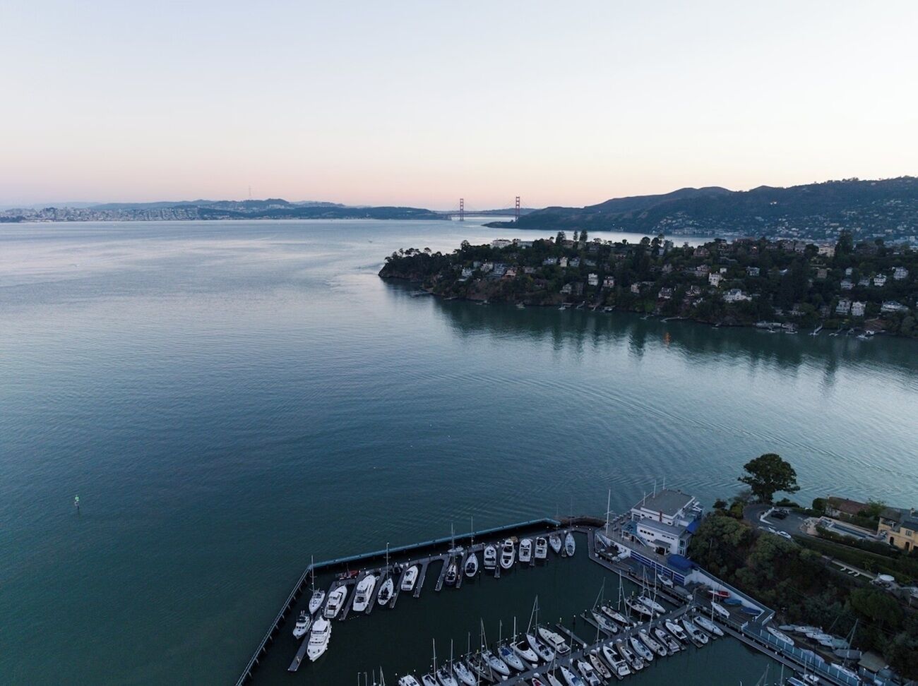 Dream over bay panoramas and marina lights at dusk.
