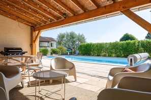 An outdoor patio with a pool, a grill, and lounge chairs. - Villa "De L’Olivier" with Private Pool, Wi-Fi, and Air Conditioning (Labégude)