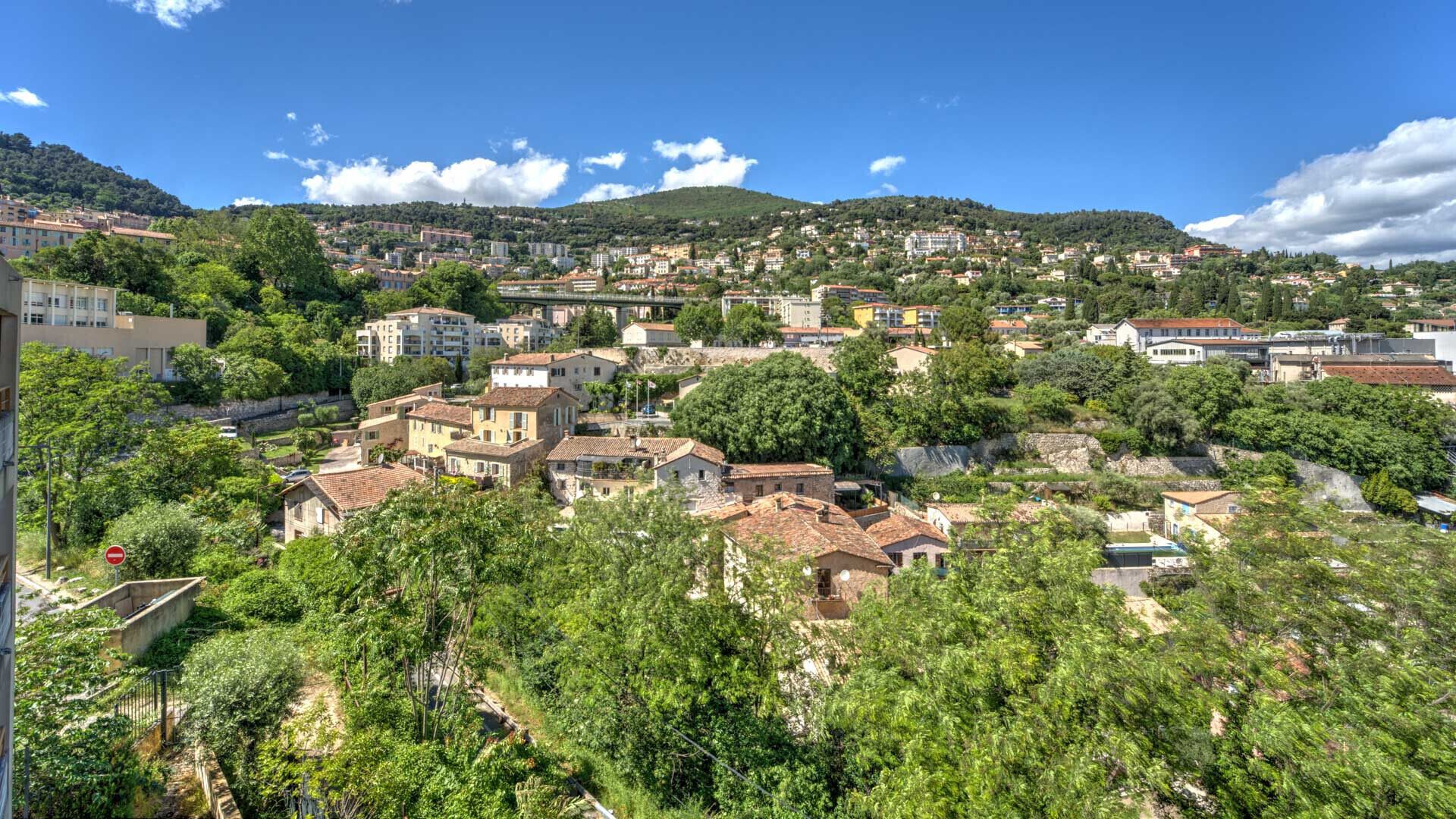 A hillside town with traditional architecture, terraced houses, and a mix of residential and commercial buildings.