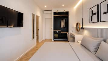 A modern bedroom with a bed, bedside table, and a walk-in closet.