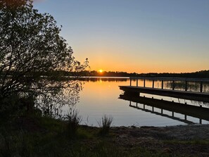 A calm lake at sunset with a dock extending into the water. - 5 Star Holiday Home in Ansager (Ansager)