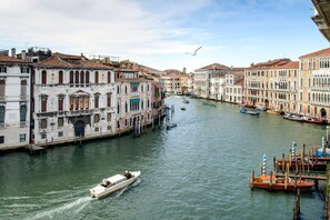 A canal with boats, historic buildings, and a seagull in the sky. - Venice Prestige - Celestina on the Grand Canal R&R (Venice)