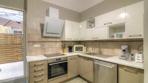 A modern kitchen with a built-in oven, microwave, and coffee maker. - CLOCARLUCCI - AJACCIO (AJACCIO)