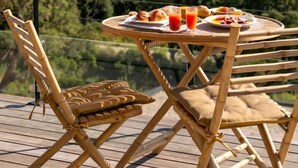 A table with breakfast items and a view of a forested landscape. - Villa Rocher - SAINTE LUCIE DE PORTO VECCHIO (SAINTE LUCIE DE PORTO VECCHIO)