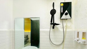 A bathroom with a white sink, a mirror, a handheld showerhead, and a wall-mounted control panel. - H-Hub BBT (Bang Bua Thong)