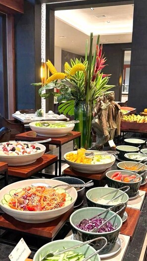 A buffet with various dishes, a decorative plant, and a sign indicating 'Thai Beef Salad'. - Golden Plaza Hotel - Free Massage & Half Board Included (Baku)