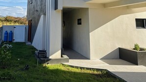 A modern building with a flat roof, large windows, and a concrete facade. - Earth at Haven+ | Refined Island Escape (St.kitts)