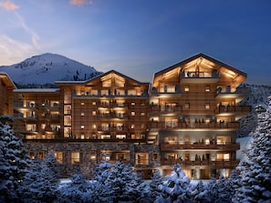 A multi-story hotel with balconies, wooden exterior, and snow-covered surroundings. - Résidence Barma Courchevel (Courchevel)