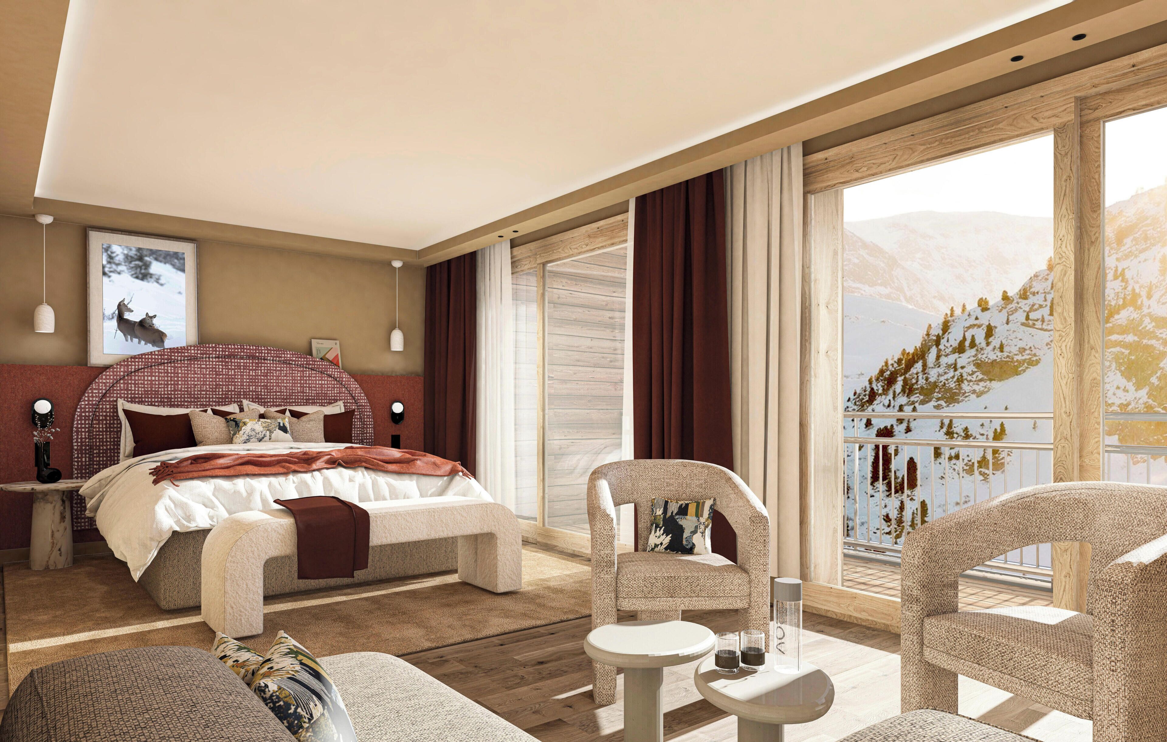 A modern hotel room with a large bed, a sitting area with a table and chairs, and a balcony with a mountain view.