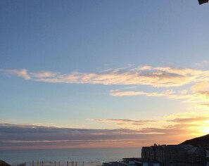 A coastal view with buildings and a clear sky. - Lowenna (Newquay)