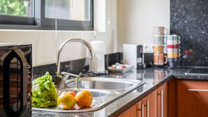 A kitchen with a sink, countertop, and a window. - Sweet Orchard Escape - By Wehost (Porto Moniz)