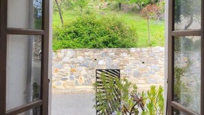 An open door with a view of a stone wall, a potted plant, and a lantern. - The Milky Way - ERBAJOLO (ERBAJOLO)
