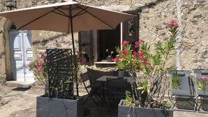 An outdoor seating area with a table, chairs, and a large umbrella. - The Milky Way - ERBAJOLO (ERBAJOLO)