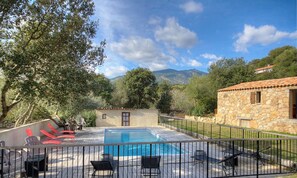 A swimming pool with a view of mountains, surrounded by stone buildings and trees. - Bergerie de Petralonga2 (SOTTA)