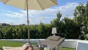 A sunlit outdoor seating area with a table set for two, featuring a bottle of champagne, glasses, and snacks. - Borgo degli Ulivi – An Authentic Sicilian Countryside Getaway with a Private Pool (Roccazzo)