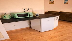Een kleine keuken met een magnetron, broodrooster en koelkast.