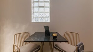 A room with a table, two chairs, a laptop, and a window with a view. - Anese Vacation Feelings (Paliouri)