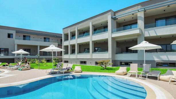 A modern hotel with a swimming pool, sun loungers, and a well-maintained lawn. - Anese Vacation Feelings (Paliouri)